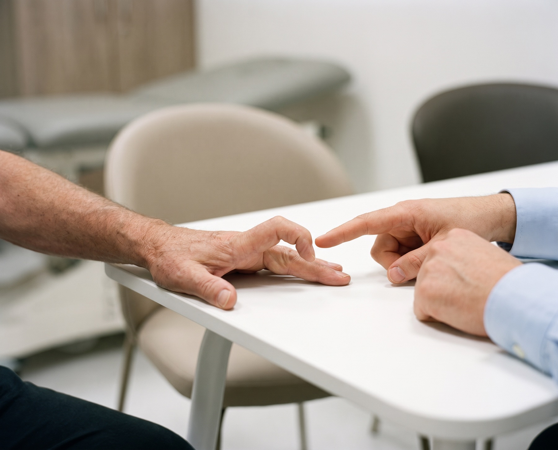 Consultant examining a hand with Dupuytren's contracture