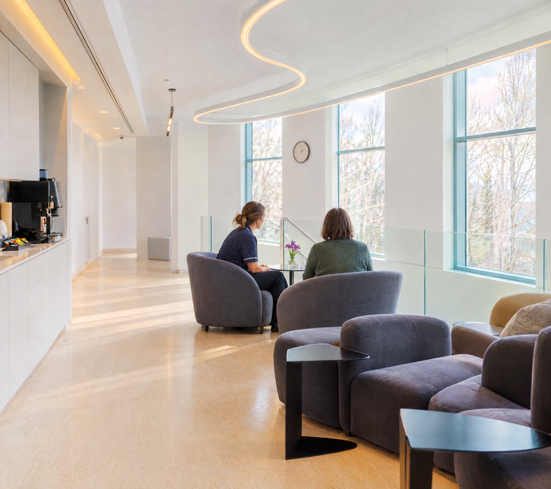 Staff member listening to a visitor in the patient lounge