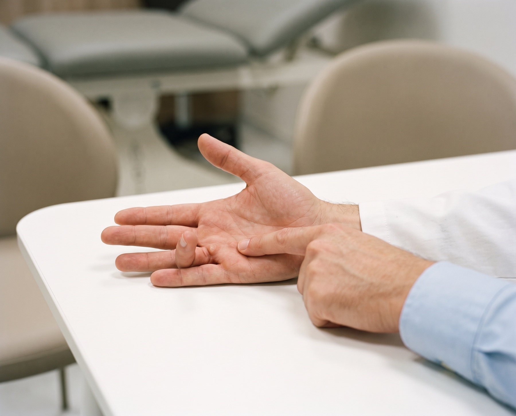 Consultant examining a trigger finger